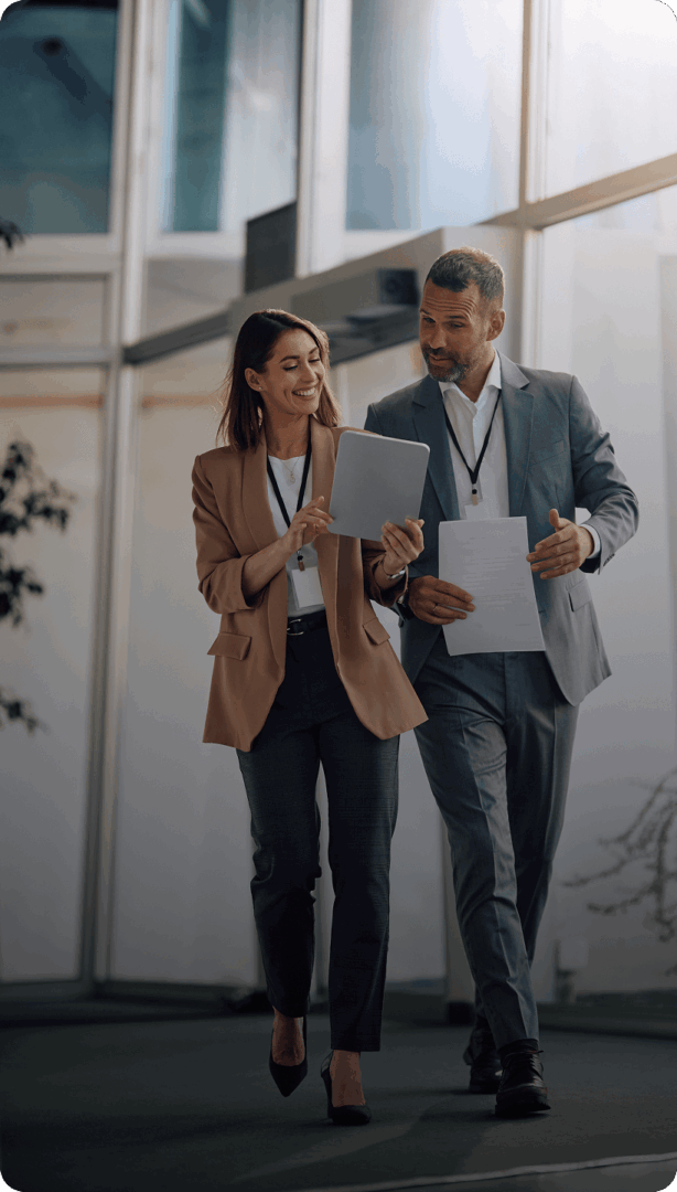 Business colleagues walking and discussing documents.